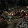 A dead Slasher necromorph lies on the ground in Dead Space.