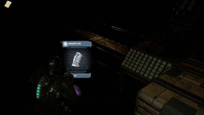 Dead Space image showing Isaac staring at Benson's RIG in the dark.