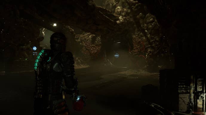 Isaac looks at a door crowded by Necromorphs in Dead Space