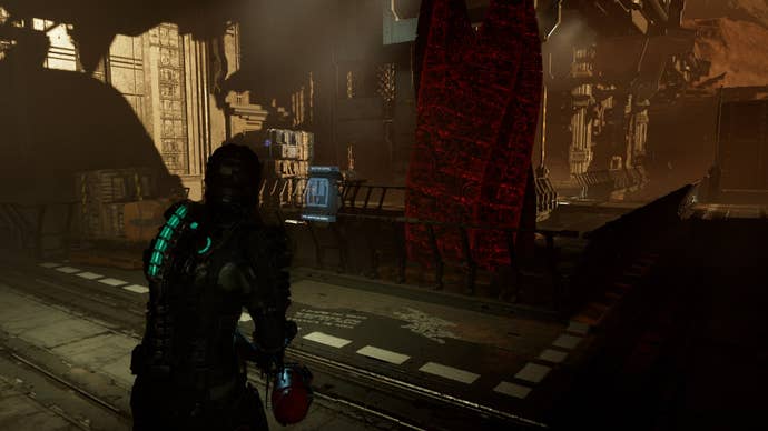 Isaac looks at a control panel in front of The Marker in Dead Space