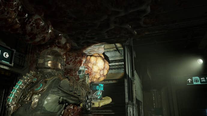 Dead Space image showing Isaac aiming a flashlight at a yellow weak point of Necromorph growth.