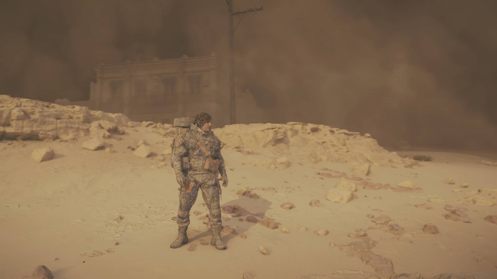 death stranding 2 screenshot - a sand storm coats Sam in dust from head to toe