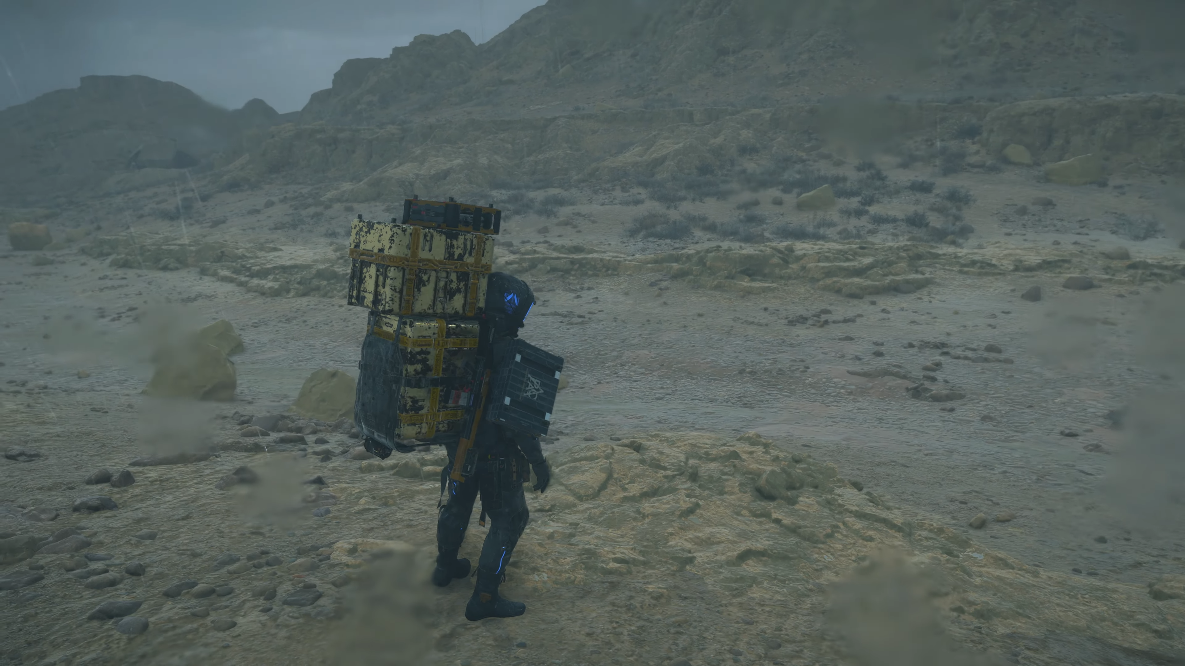death stranding 2 screenshot - a dry riverbed and rainfall