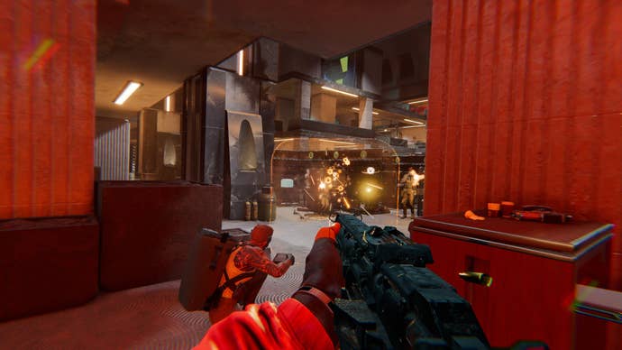 One man shoots a gun into a vault chamber as another crouches and takes aim at enemies unseen.