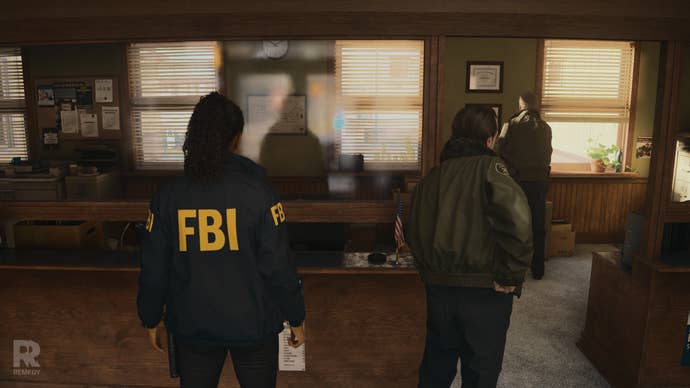 Scene from Alan Wake 2 showing the back of Saga’s FBI jacket
