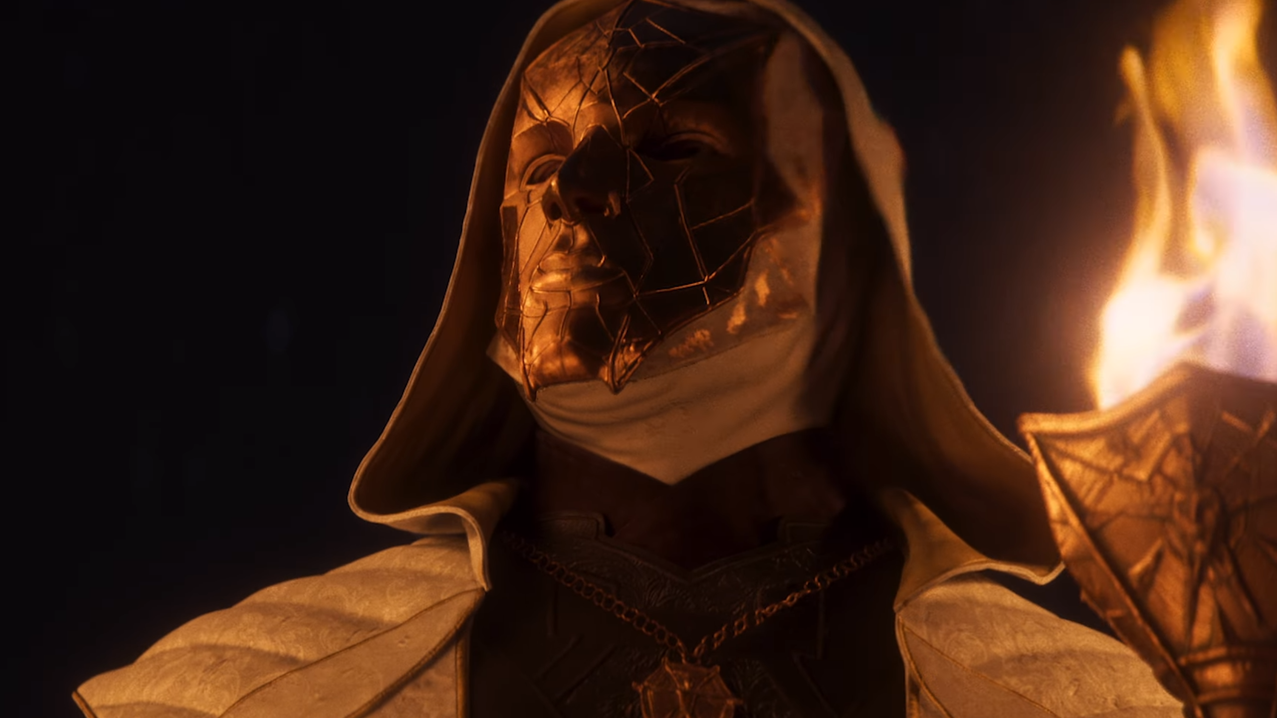 Divinity trailer showing close up of mysterious cloaked masked figure holding a flaming torch