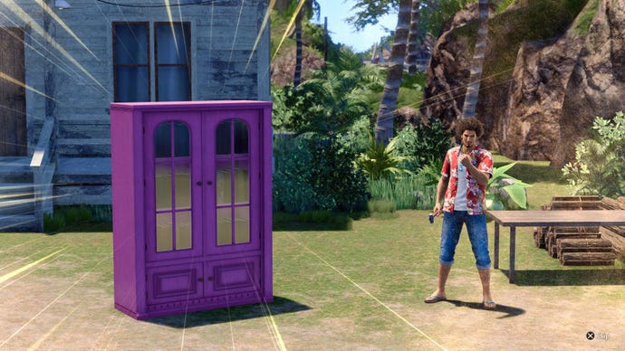 Ichiban stands next to a big purple cabinet he's just built on LAD: Infinite Wealth's Dondoko Island.