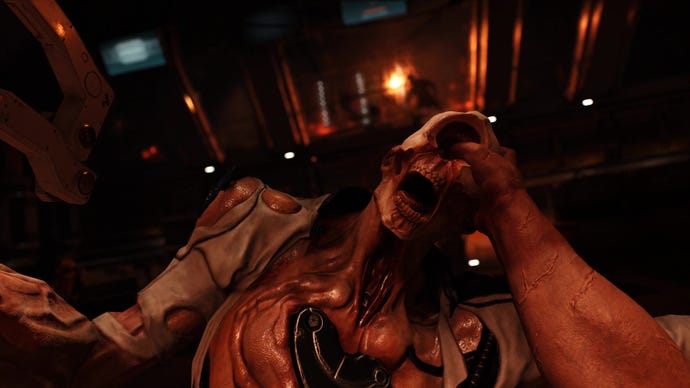 A hand grasps a zombieman skull in Doom 2016