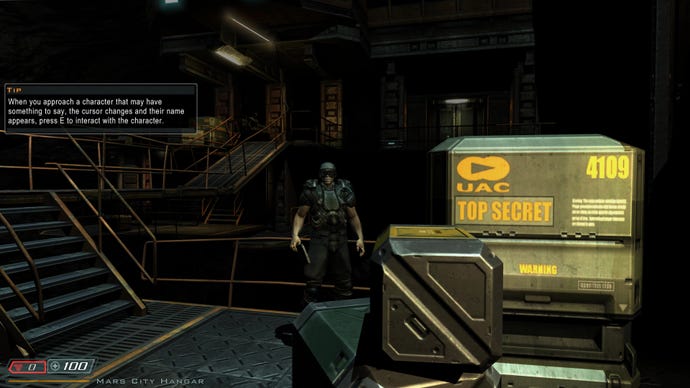 An NPC stands next to top secret UAC boxes in Doom 3