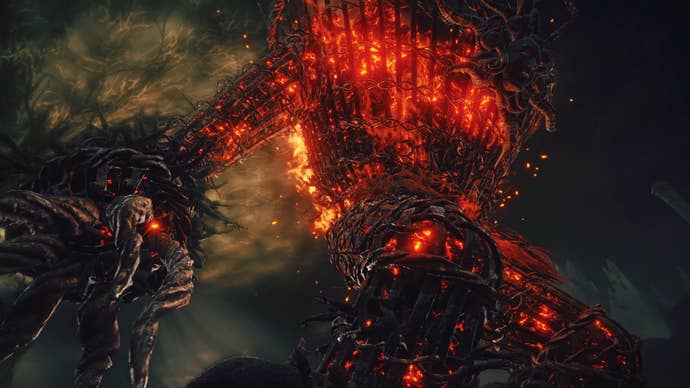 Towering flaming giant with cage-like body on fire against dark sky