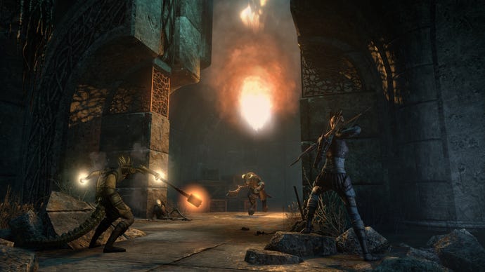 Two warriors approach a monster in a dark cave in The Elder Scrolls Online's Gold Road Chapter