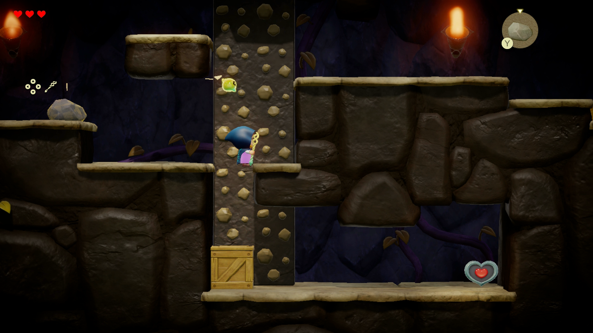 Princess Zelda climbing down a rock wall inside the Beach Cave to reach a Heart Piece in Zelda: Echoes of Wisdom. - 1