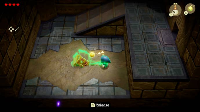 Princess Zelda pulling a partially submerged treasure chest out of a pit of sand in Zelda: Echoes of Wisdom.