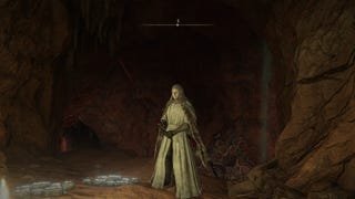 The player stands outside of the entrance to Caelid's Abandoned Cave in Elden Ring