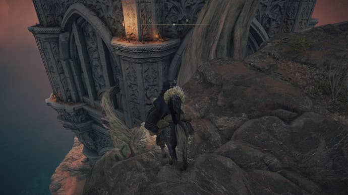 The player approaches the Divine Tower of Caelid from the east, where tree branches leading to the climbable exterior of the building can be seen in Elden Ring