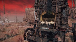 The player stands in front of a carriage in Elden Ring while holding the Greatsword