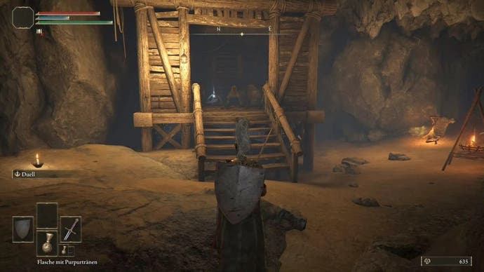 Armored figure looking at an aggressive dog in a wooden hut in the Limgrave Tunnels in Elden Ring.
