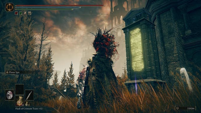 Armoured character looking at the stele with the Rauh Ruins map fragment below it in Elden Ring Shadow of the Erdtree DLC.