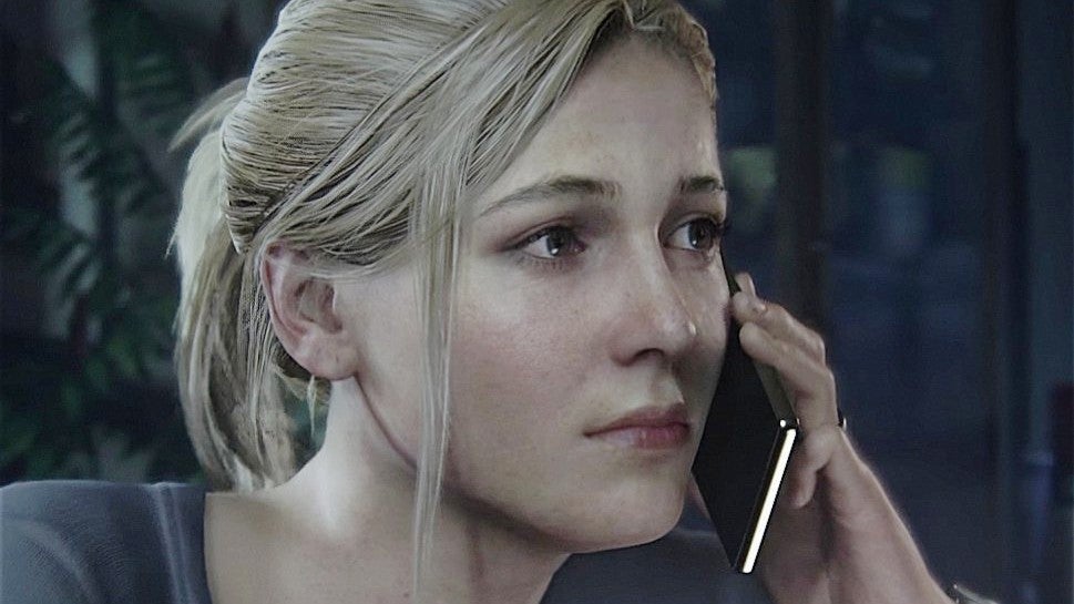 Elena Fisher on the phone in Uncharted 4. She has her blonde hair pulled back loosly and a blue top on