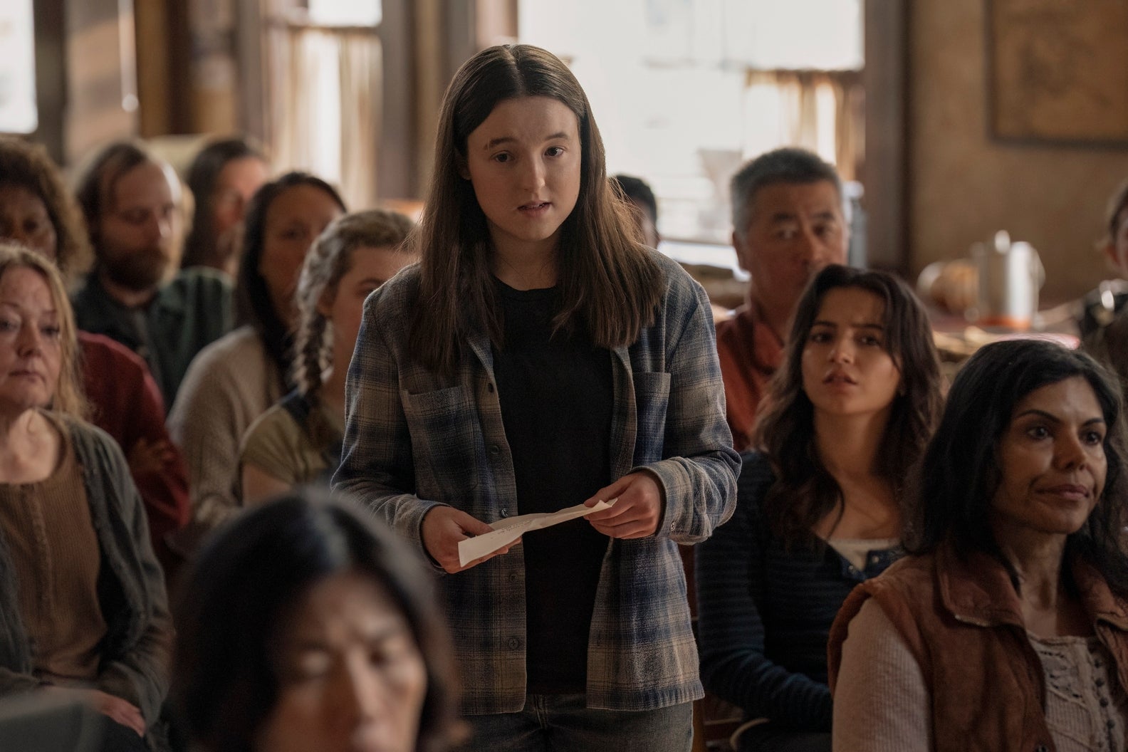 Ellie and Dina at the Jackson town meeting in The Last of Us season two