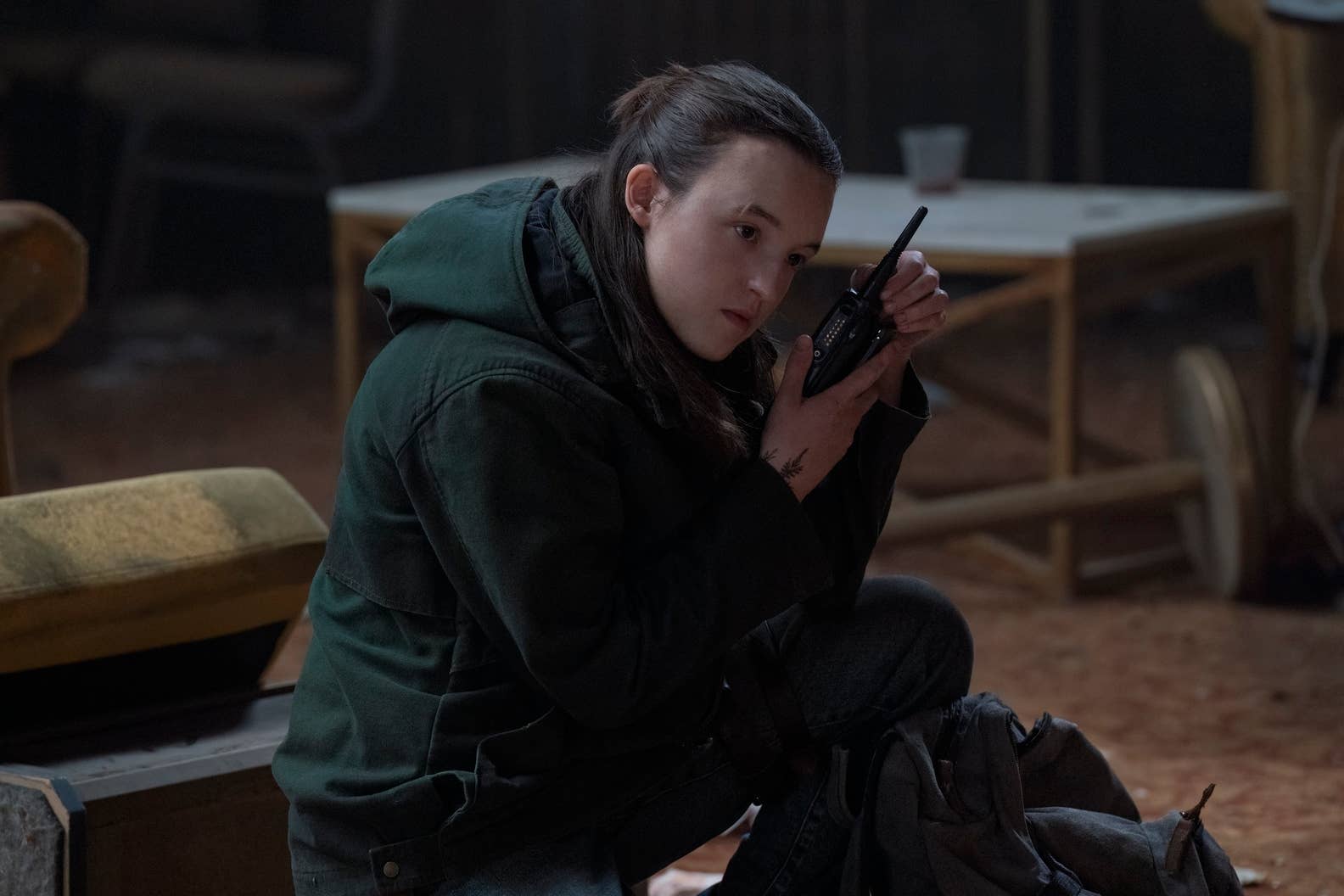 Ellie listens to a walkie talkie in TLOU season two