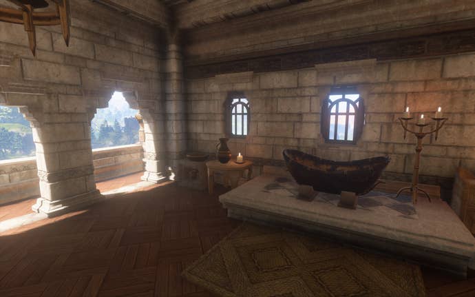 A fancy-looking room in a high tower with a balcony, with a copper bathtub, washbasin and bronze vases.