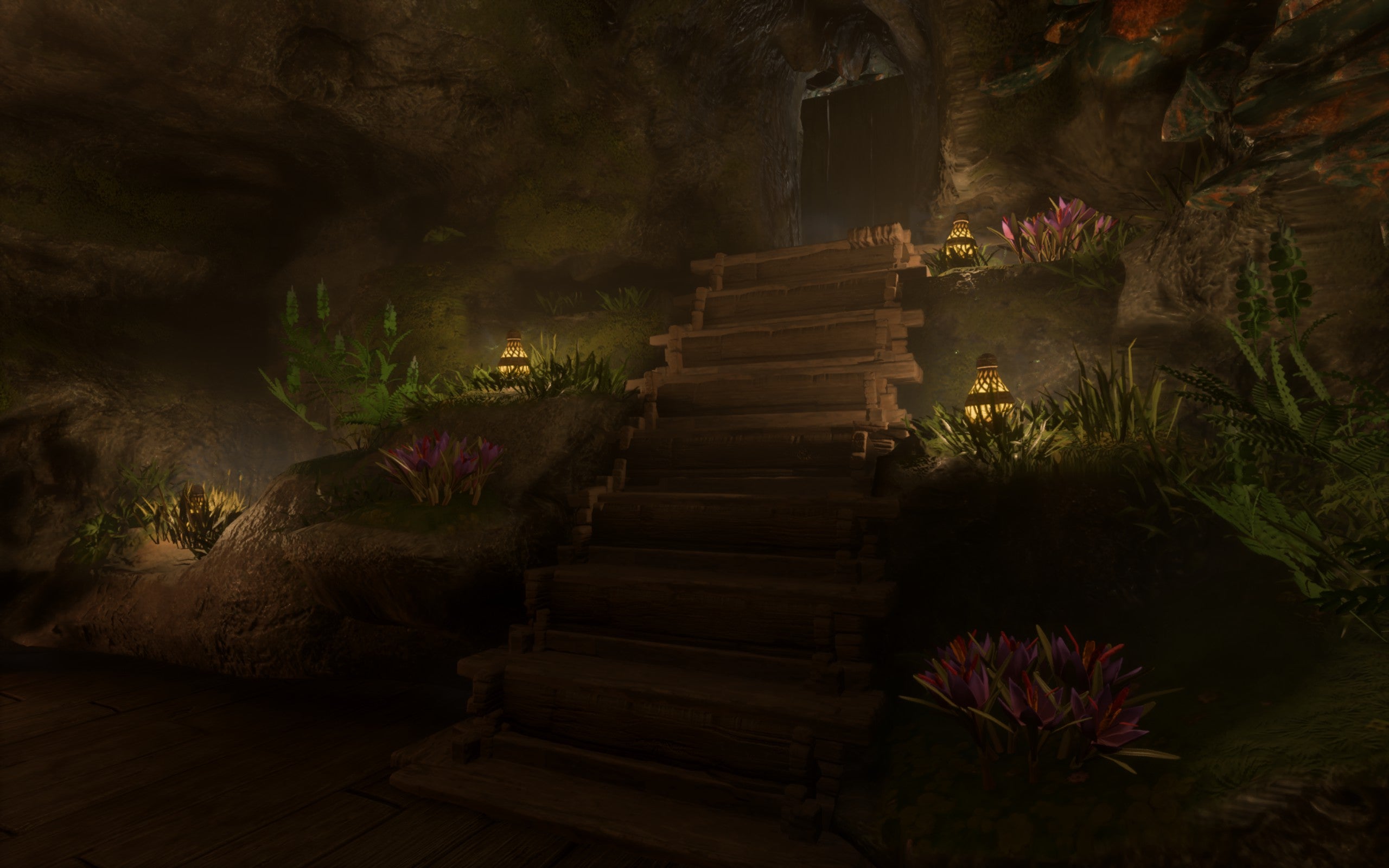 A wooden staircase leads down into an underground room. At the side of the staircase are tufts of grass and flowers, with firefly lamps placed on the floor to create a magical fairy theme.