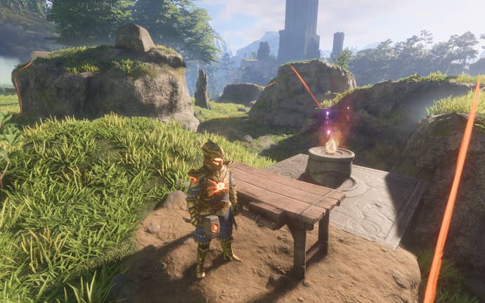 The player-character holds a hammer and stands next to a wooden Workbench.