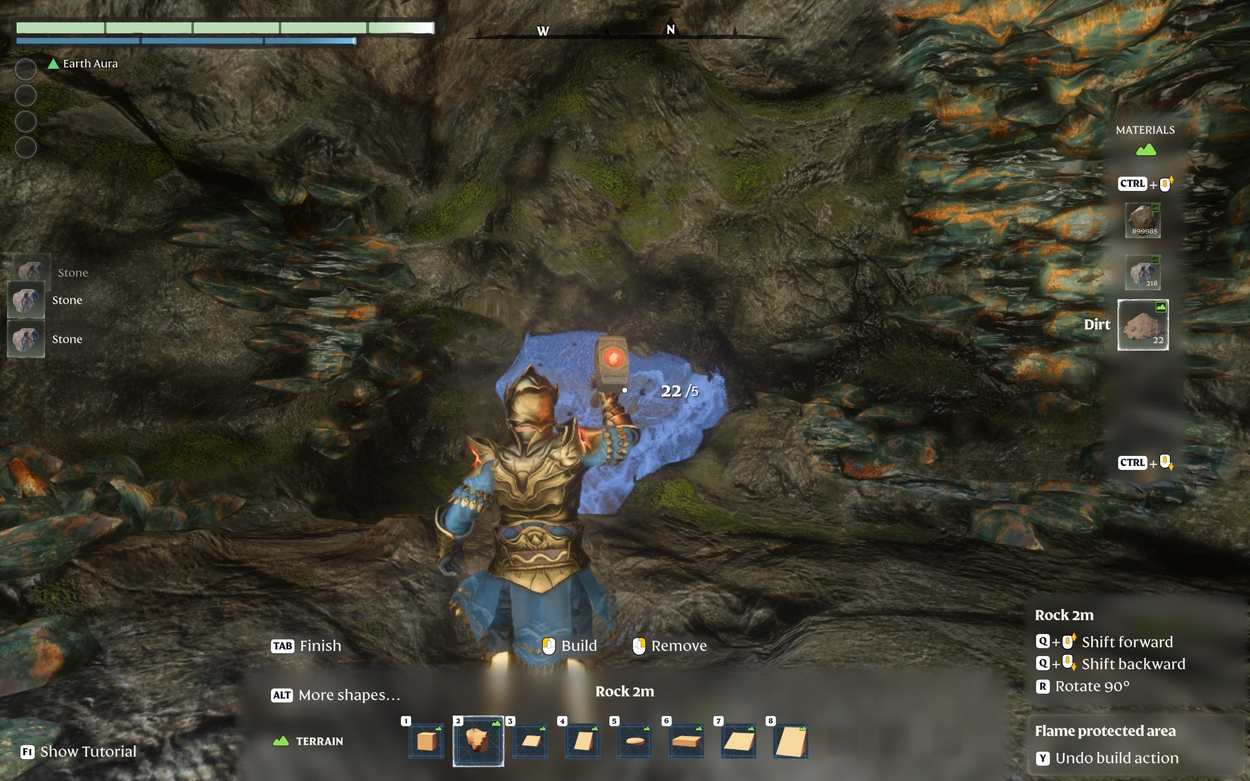 The player-character, using Enshrouded’s building system, deletes terrain in the shape of a lumpy block. The building system shows a preview of this as a glowing outline.