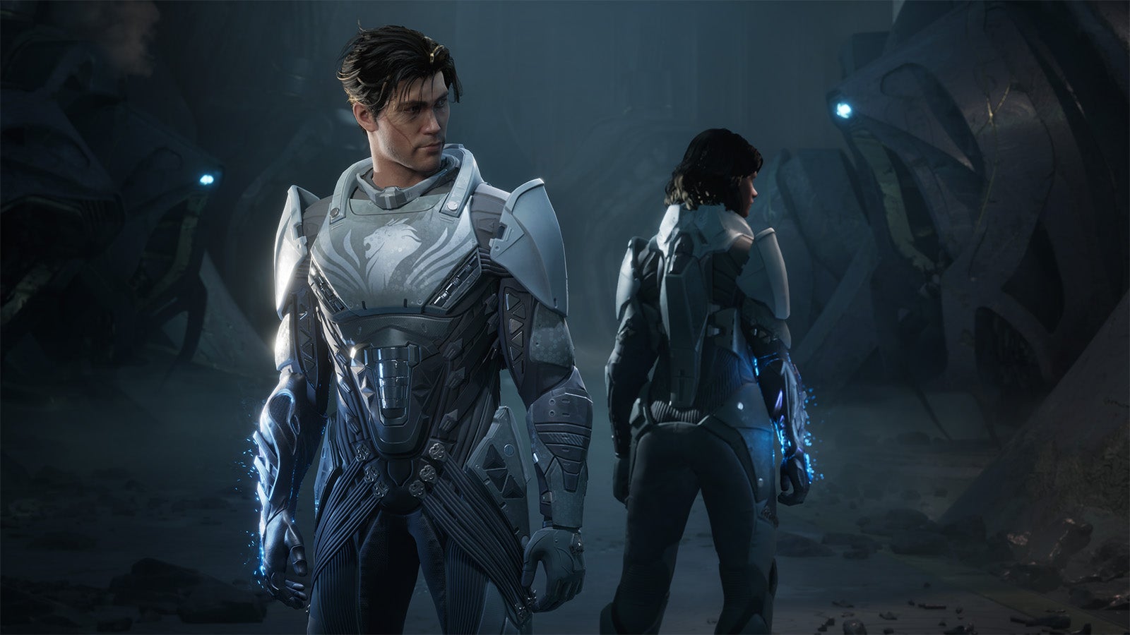 Two character stand back to back, each a different gendered version of each other. They both wear the same grey space combat suit and have a glowing gauntlet on their right hand.