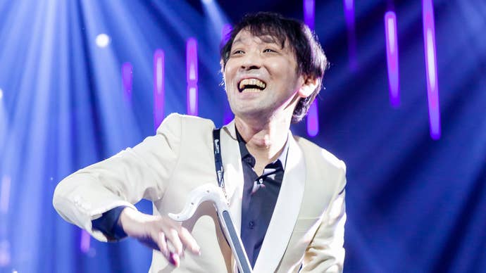 Masayoshi Soken at the Vegas Final Fantasy Fan Fest in a white jacket playing an otomatone