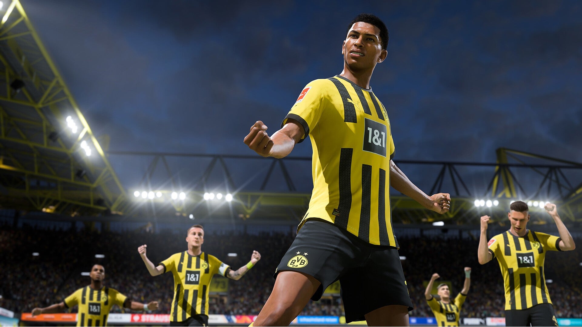 FIFA 23 image showing Borussia Dortmund players celebrating on the pitch at night.