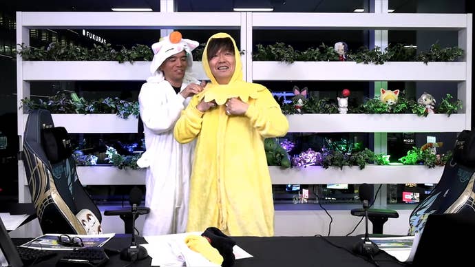 Final Fantasy 14’s Naoki Yoshida in a yellow chocobo onesie and Toshio Murouchi in a white moogle onesie