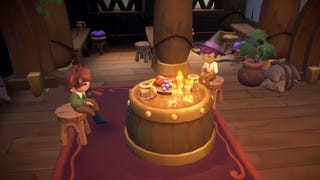 Two characters sit around a barrel with candles and food in Fae Farm