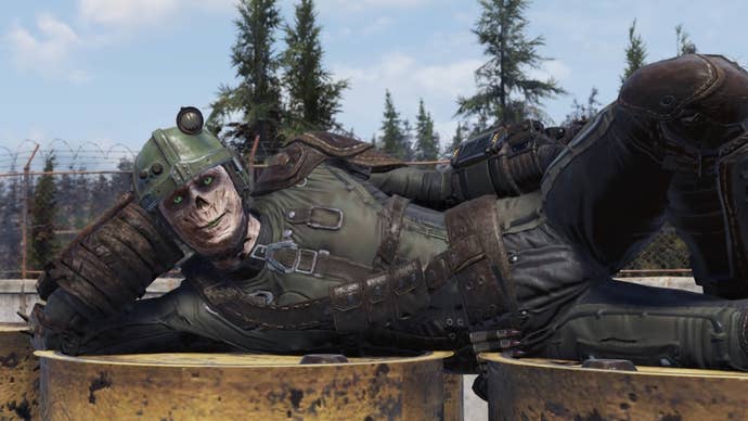 A ghoul lies on top of radioactive barrels in Fallout 76.