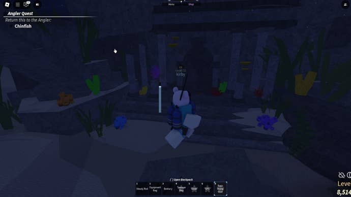 The player, swimming beneath Grand Reef, prepares to place TNT by a doorway blocked with rubble in Fisch