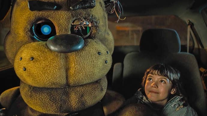 Five Nights at Freddy’s film screenshot showing golden Freddy in a car