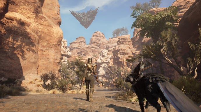 A woman walking down a forested sandy canyon towards a strange floating rock in the distance