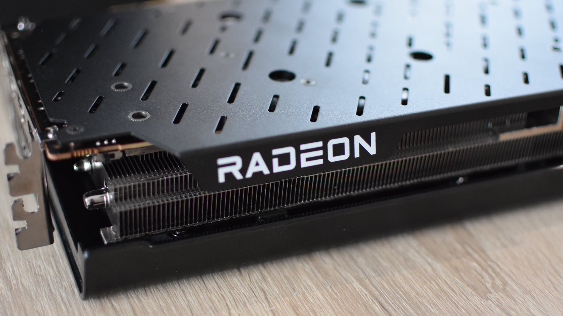 The Radeon logo on an RX 7700 XT graphics card. - 1