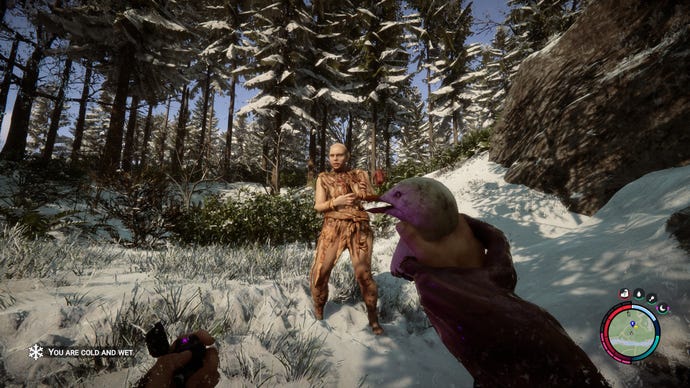 The player holds a bird and a lighter in either hand as a zombie approaches in a snowy forest in Sons Of The Forest