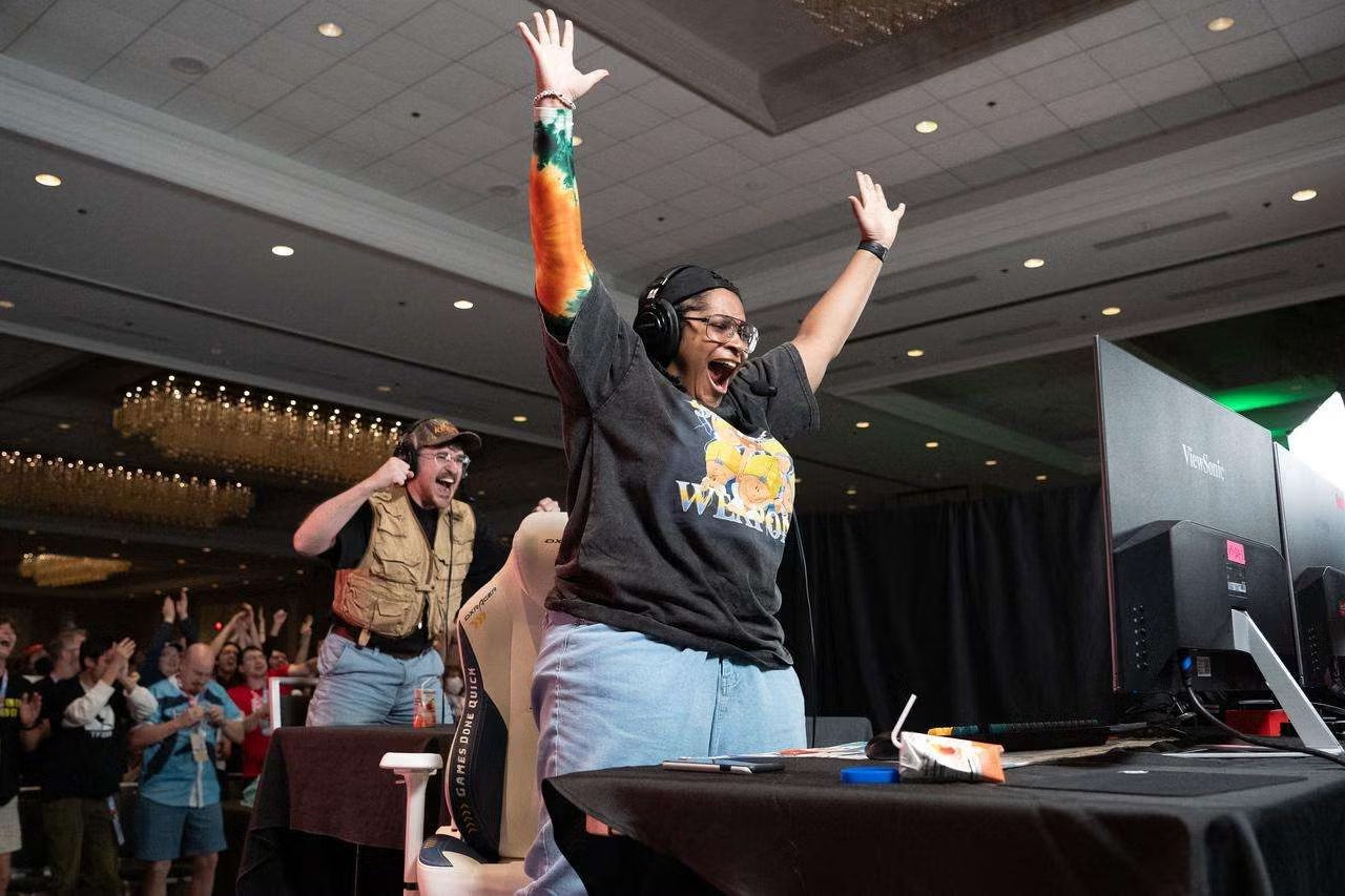 A person with arms up, celebrating an achievement in a speedrun at Games Done Quick