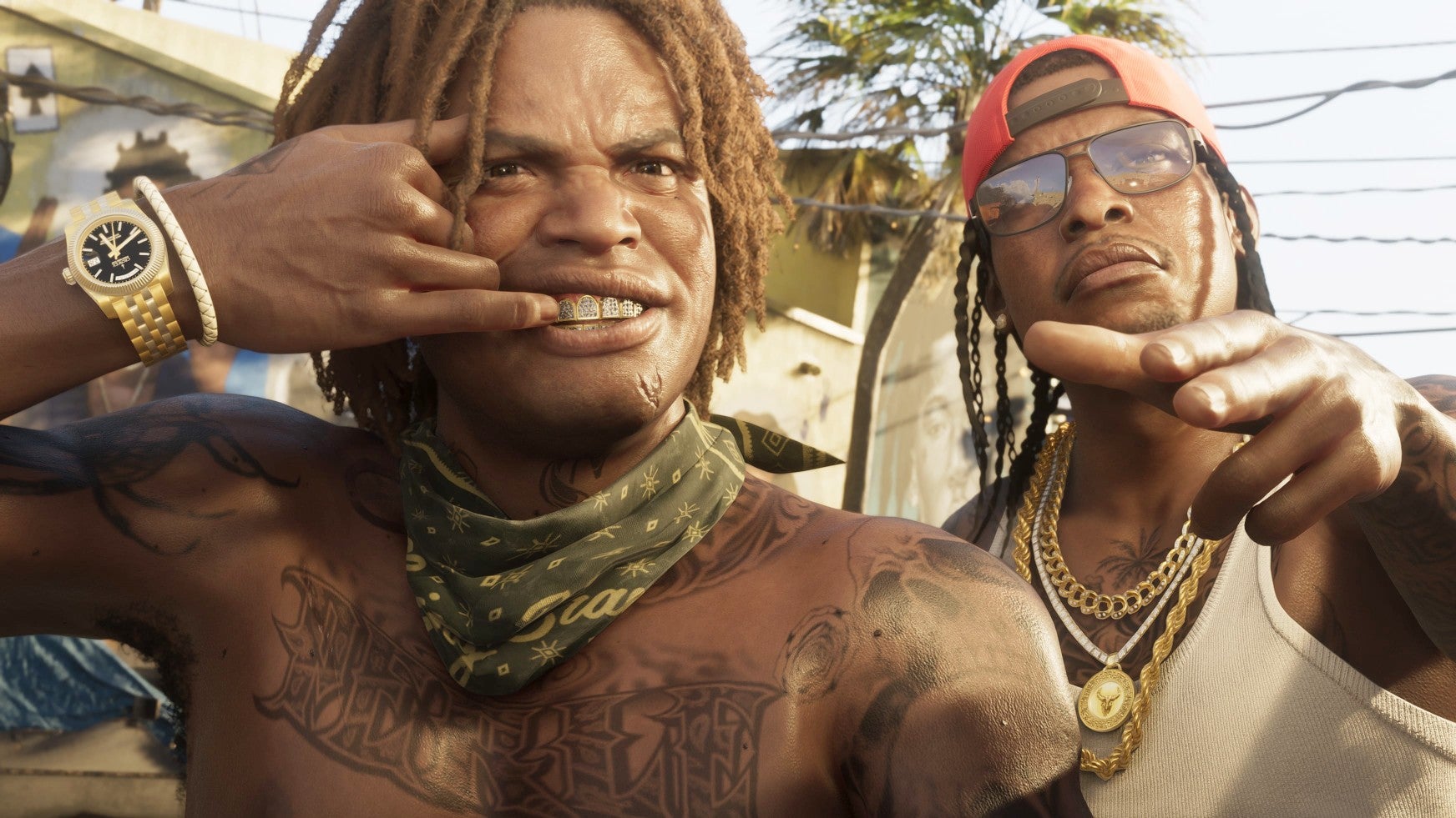 GTA 6 image showing to male characters in Vice City. The man o the left is shirtless and has tattoos over his body but a bandana around his neck. He has a gold watch and is exposing his teeth. The other man has glasses and a red cap on and is reaching out