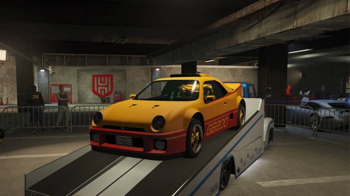 GTA Online Prize Ride, a Yellow and Orange Vapid GB200 sitting on the back of a white Slamtruck