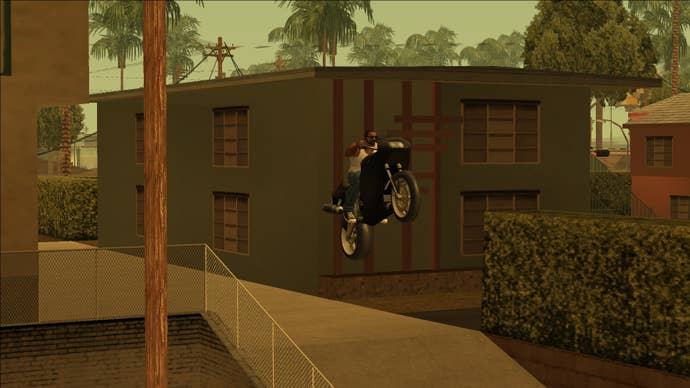 CJ rides a motorbike through a neighbourhood in Grand Theft Auto San Andreas