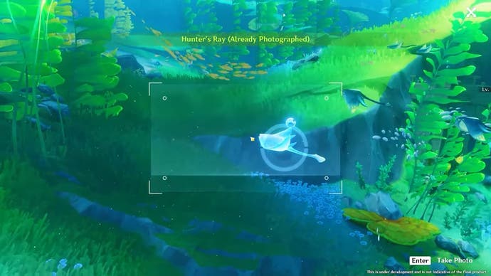 Gameplay screenshot showing the player taking a picture of a blue creature underwater.