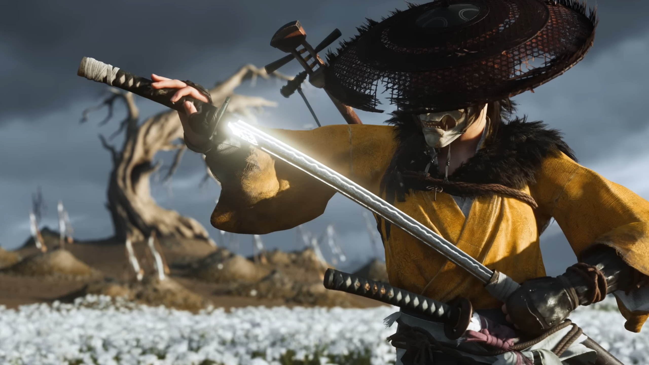Ghost of Yōtei trailer screenshot showing samurai in yellow garb and wide hat holding a katana shimmering in sunlight