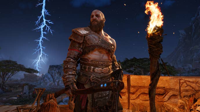 Kratos in God of War Ragnarok looking off the the left in front of a night sky with lightning in the background.