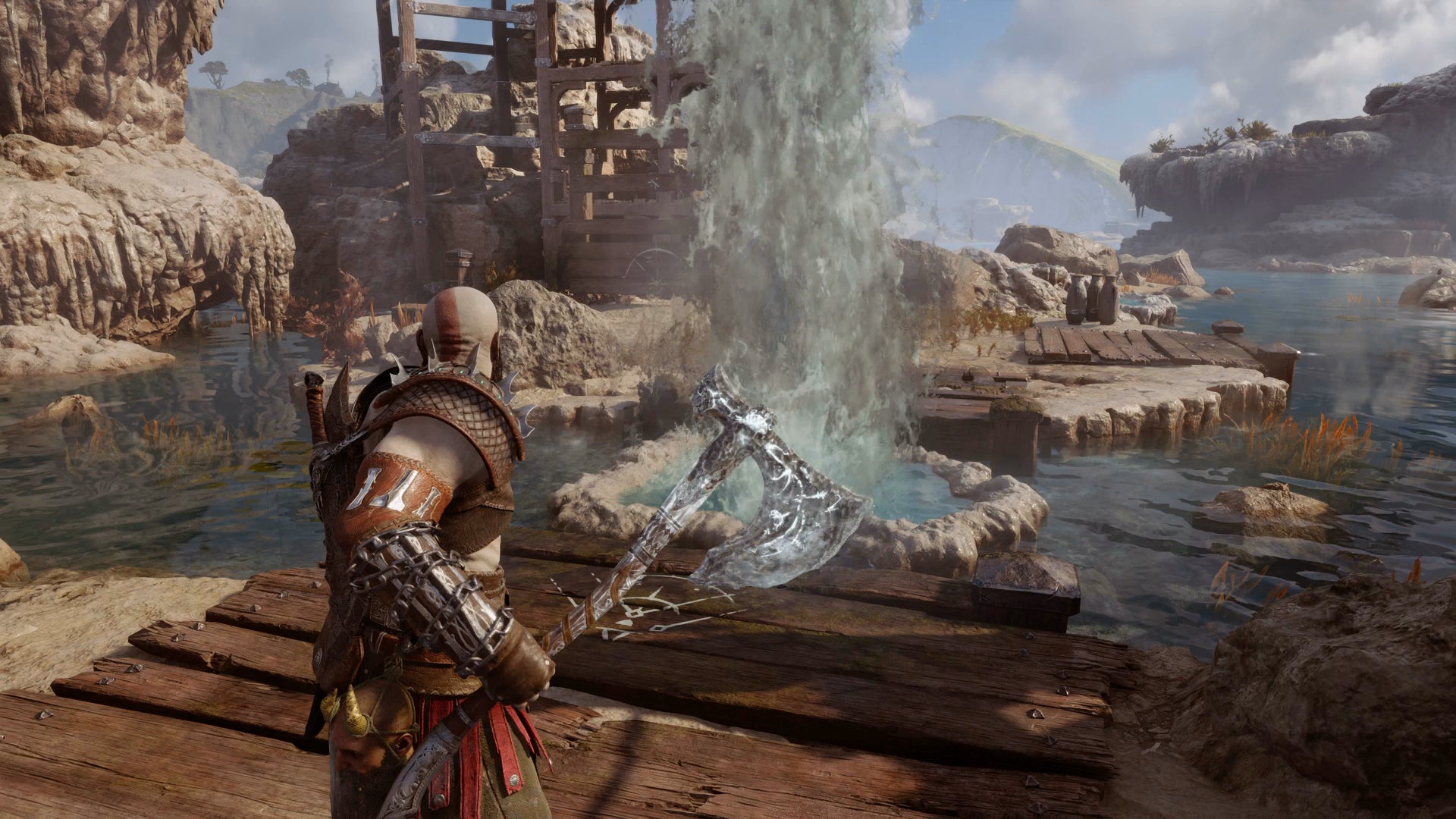 Kratos freezing a geyser with his axe in the Aurvangar Wetlands in God of War Ragnarok - 5