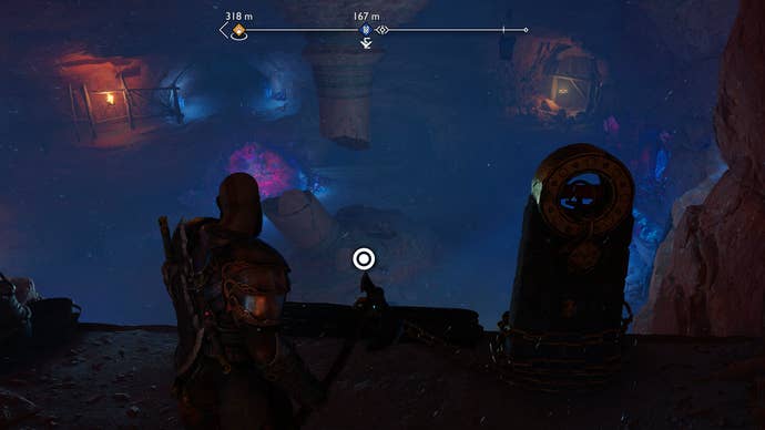 Kratos sliding down a chain to reach a cave floor in God of War Ragnarok
