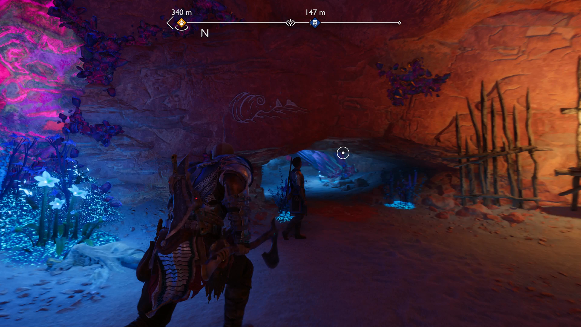 Kratos and Atreus stooping through a narrow hole in the Below in God of War Ragnarok